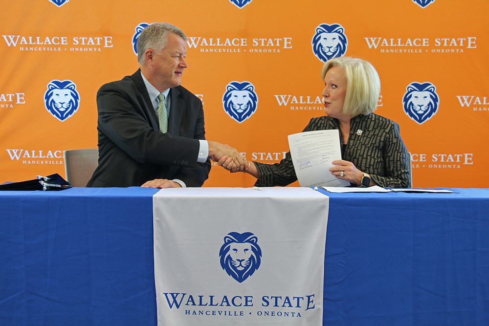 John Riley of Cullman Savings Bank shakes hands with Wallace State President Dr. Vicki Karolewics after signing the Powerful Partnerships Agreement.